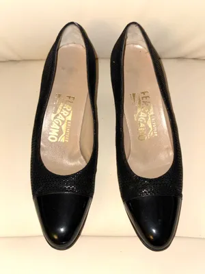Salvatore Ferragamo black textured patent leather heels with a vintage-style toe cap. The rest of the shoe has a subtle texture. Made in Italy. thumbnail 1