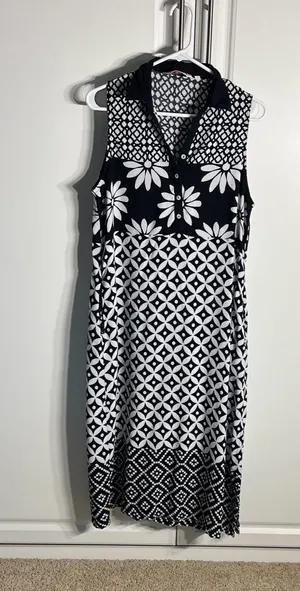 Chic sleeveless black and white dress with bold floral and geometric patterns. Lightweight and breathable for comfortable all-day wear. Collared neckline adds a polished touch and pockets. Easy to style for casual or dressy occasions. BIBA size medium thumbnail 1