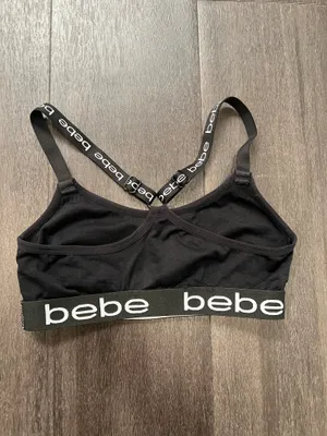 Sleek black bralette featuring bold bebe logo on elastic band. Stretch fabric for light support and comfort. Thin adjustable logo straps with a stylish crisscross back. Clean, minimalist look ideal for layering. Bebe size small thumbnail 3