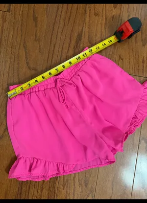Hot Pink flowy ruffle-hem shorts with elastic drawstring & lightweight - Size M. relaxed design. Gently warn and excellent condition. Measurements approximately 12” waste, not fully stretched out x 12” long. Non-smoking home. priced to sell at as is condition. Don’t like my price, make reasonable offer! And thank you for checking my closet. thumbnail 5