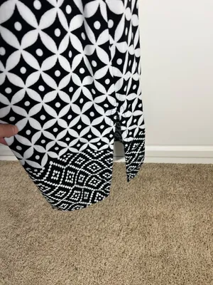 Chic sleeveless black and white dress with bold floral and geometric patterns. Lightweight and breathable for comfortable all-day wear. Collared neckline adds a polished touch and pockets. Easy to style for casual or dressy occasions. BIBA size medium thumbnail 3