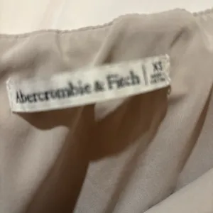 Abercrombie & Fitch tan asymmetrical wrap front mini skirt thumbnail 3