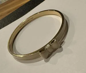 Kate Spade Signed Bangle Bracelet Bow Tie Creamy White / Gold Tone - 7 3/4 Inch thumbnail 10