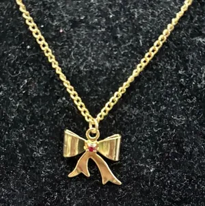 Gold Bow Pendant Necklace with Red Accent thumbnail 1