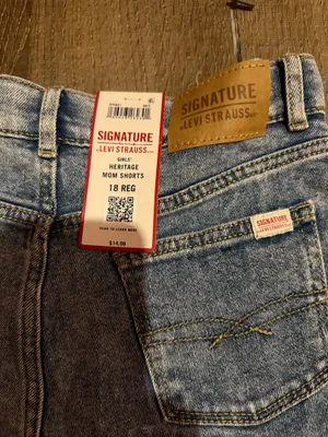 Signature Levi Strauss light blue denim shorts with delicate floral embroidery. Comfortable high-rise fit designed for everyday wear. Soft, faded blue wash that pairs easily with casual tops. Floral detailing adds a feminine touch. thumbnail 4