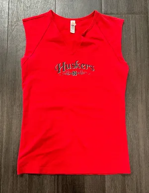 Bella Canvas Comfortable red sleeveless V-neck top with Huskers chest logo. Soft, breathable fabric for everyday wear. Clean, fitted silhouette that layers easily. Machine washable for easy care. size medium thumbnail 1