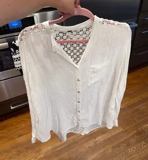 Free People button-front blouse features delicate crochet detailing‎ along small thumbnail 1