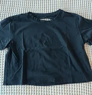 Black crop top with cutout detail and stacked stone graphic #cutout #stone thumbnail 1