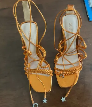 Schutz Lunah strappy sandals in a metallic gold finish. thumbnail 1
