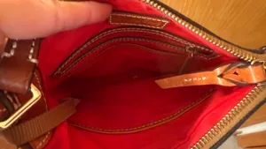 This is a Dooney & Bourke black pebbled leather crossbody thumbnail 6