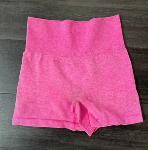 Comfortable high-waist seamless shorts in vibrant pink. Soft, stretchy fabric for unrestricted movement. Smooth waistband provides a flattering, secure fit. Ideal for workouts, yoga, or everyday wear. Size small thumbnail 1