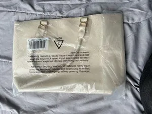Ulta Beauty Tote Bag – Cream (New in packaging) Add a clean, elegant touch to your outfits with this beautiful tote! It comes in a super versatile cream/ivory shade, featuring a textured faux-leather finish and unique braided handles that give it a chic look. thumbnail 2