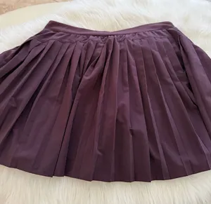 SPANX Pleated Athletic Skort in Plum Purple thumbnail 1