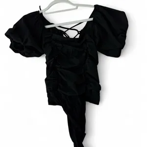 black bodysuit cap sleeves and open back with tie. size medium. thumbnail 1