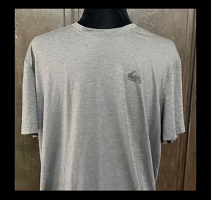 QuikSilver Gray /Charcoal T-shirt - size Large. Gently Warn & in excellent condition. Innovate your future printed on back tail. True color is the ones with measurements. Measurements approximately 22” from armpit to armpit x 26” long. Non-smoking home. priced to sell at as is condition. Don’t like my price, make reasonable offer! And thank you for checking my closet. thumbnail 3
