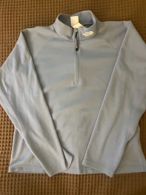 light blue north face woman’s quarter zip turtle neck vest in a size L thumbnail 1