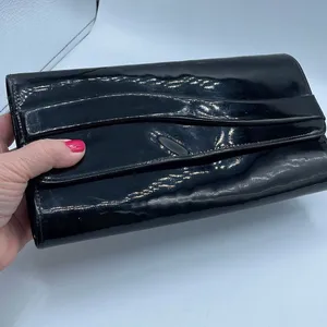 Black faux patent leather clutch with wave design on front. thumbnail 2