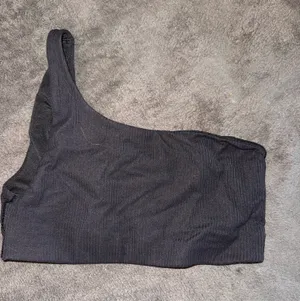 Lululemon Black Ribbed Nulu Asymmetrical Yoga Bra thumbnail 1