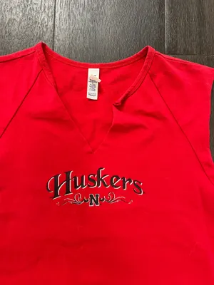 Bella Canvas Comfortable red sleeveless V-neck top with Huskers chest logo. Soft, breathable fabric for everyday wear. Clean, fitted silhouette that layers easily. Machine washable for easy care. size medium thumbnail 4