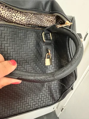 black woven duffle bag with gold hardware, some wear in the handles, no brand. thumbnail 4
