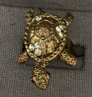 Vintage Bronze Turtle with Rhinestones Expansion Ring - size 7. can have bigger fingers to fit. Beautiful & fun conversation piece. Feet & tail move. Gently warn & Excellent condition. None smoking home. priced to sell at as is condition. Don’t like my price, make reasonable offer! And thank you for checking my closet. thumbnail 1