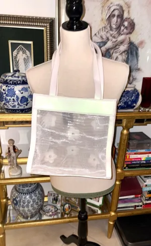 Christian Siriano's elegant translucent mesh tote bag stands out for its delicate black and white floral appliqués. thumbnail 2