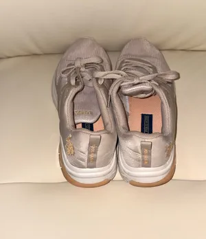 The sneakers are from the U.S. Polo Assn. brand in a pale pink tone with breathable mesh. thumbnail 4