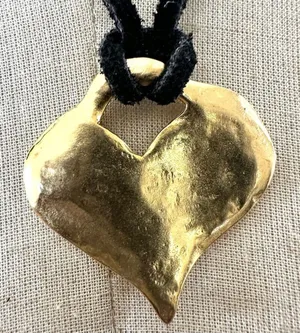 Gold tone heart pendant necklace on black cord thumbnail 1