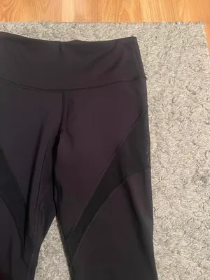 Black stretchy Yvette leggings with mesh design on outer thighs and ankles #activewear No flaws The lighting makes it look a little brown but they are plain black leggings I am a 26 in waist and 5'6" for reference thumbnail 2