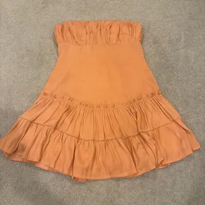Saints + Secrets Strapless Ruched Tiered Midi Dress in Peach Orange thumbnail 1