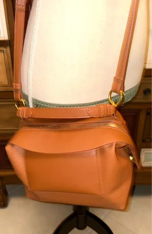 The Free Assembly brown bag features a faux leather structure with top handles and a removable crossbody strap. thumbnail 3
