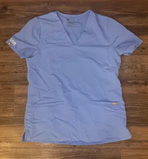 Figs women’s ceil blue scrub top with Aya Healthcare logo thumbnail 1