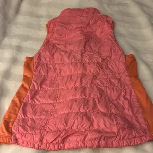 a Tangerine women's puffer vest in pink with orange side panels. Size large thumbnail 4