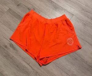 Aerie x Smiley Orange Sweat Shorts - Size XL (Like New) Description: Upgrade your loungewear with these vibrant, bright orange Aerie x Smiley fleece sweat shorts! As seen they feature a comfy elastic waistband, handy side pockets, and a cute "Cabana Beach Club" smiley logo on the left hem. Condition: Excellent, like-new condition with no visible flaws Size: XL / TG Details: Soft fleece lining, perfect for beach days or casual lounging. Close-up of the graphic logo can be found Super cozy and ready for a new home! Fast shipping. thumbnail 1