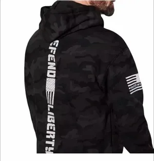 Howitzer "Defend Liberty" Black Camo Hoodie Elevate your casual wear with this rugged and patriotic Howitzer "Defend Liberty" Hoodie. Featuring a stealthy black multicam (camo) pattern, this hoodie is designed for those who value both style and a strong message of freedom. Constructed with high-quality, durable fabric, it offers a comfortable fit perfect for outdoor adventures, range days, or daily wear. Product Features: • Brand: Howitzer Manufacturing Co. • Design: Bold "DEFEND LIBERTY" distressed graphic with the American flag and an AR-15 silhouette on the front. • Back Detail: A vertical "DEFEND LIBERTY" spine graphic for a unique look from every angle. • Sleeve Detail: Features the Howitzer brand American flag patch on the sleeve. • Pattern: Modern black/dark grey camouflage. • Style: Pullover with adjustable drawstring hood and a spacious kangaroo front pocket. thumbnail 6