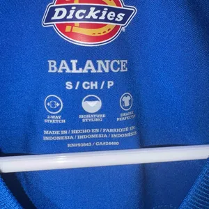 blue Dickies Balance scrub top features a v-neckline and a functional chest pocket. thumbnail 2