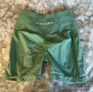 Alphalete Amplify High-Rise Scrunch Bike Shorts in Olive Green thumbnail 1