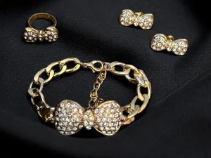 Gold tone pave bow tie bracelet, earrings and ring set thumbnail 1