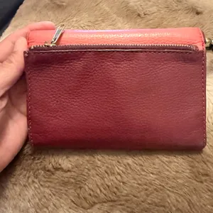 Fossil, leather bifold wallet; red/maroon Has a pen mark on the front thumbnail 2