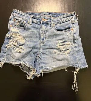 American Eagle Shortie High Waisted Distressed Denim Shorts Light Wash Blue Sz 8 thumbnail 1