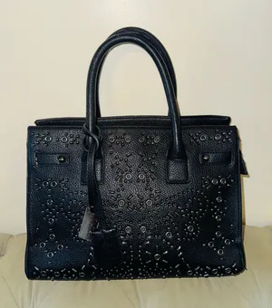Women’s black handle bag with metal design in the front thumbnail 1