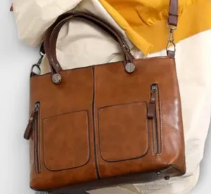 dark brown faux leather multi-pocket tote handbag featuring dual top handles and vertical front zipper pockets thumbnail 1