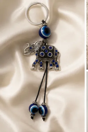Cute elephant keychain with evil eye beads. It's made of metal with blue gem accents. Attaches to a standard key ring. thumbnail 4