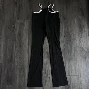 Black and white SHEIN flare pants with white trim #y2kfashion #flares Size 4 Worn once Very soft quality but don't need them anymore thumbnail 2