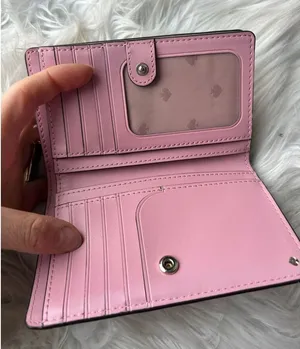 Kate Spade Adel Medium Bifold Wallet in pink and tan on the outside thumbnail 1