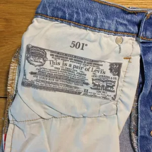 Levi’s 501 Jean shorts 26 button-fly medium wash distressed thumbnail 7