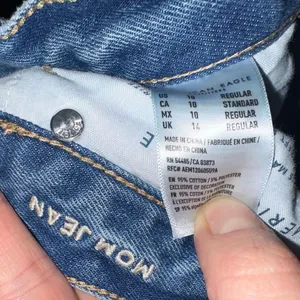 American Eagle light wash destroyedrelaxed mom jeans thumbnail 2