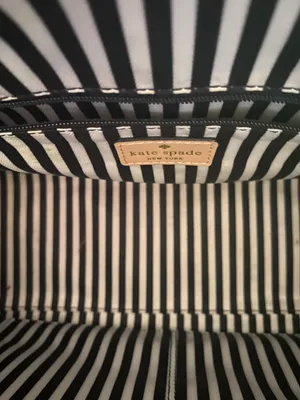 Kate Spade NEW YORK-MINT MOJITO PIPPA PARNELL STREET LEATHER SATCHEL Perfect spring bag, mint green white tan handle and crossbody strap, top zip closure, stripe print interior, inside zip pocket, inside two open pockets, amazing condition, there are two call outs, a small smudge on the bottom of the bag and a small smudge on one corner, please see the last two pictures **This bag is preowned and is being sold as is** thumbnail 11