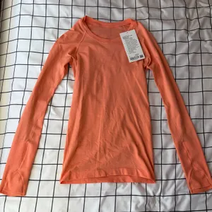 Lululemon Woman’s Coral Long Sleeve Swiftly Tech, Size 2, Hip Length. thumbnail 1