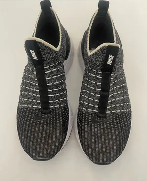 Nike Women’s Black and White Slip-On Knit Sneakers thumbnail 1